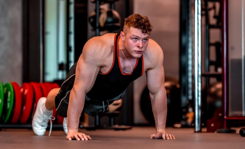 young-athlete-performs-pushups-min